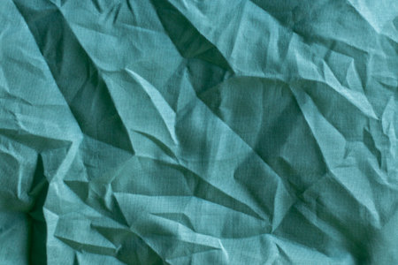 Wrinkled fabric texture in teal color for abstract backgroundの写真素材