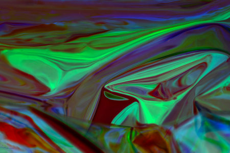 Vibrant abstract artwork featuring green and red swirling patterns and iridescent huesの写真素材
