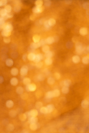Golden Bokeh Background with Warm Amber Lights for Festive and Luxury Design Projects