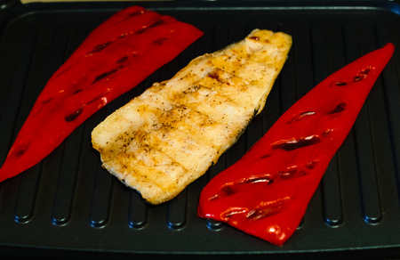 fillets of fish and Bulgarian red peppers on the grill, concept of healthy eatingの写真素材