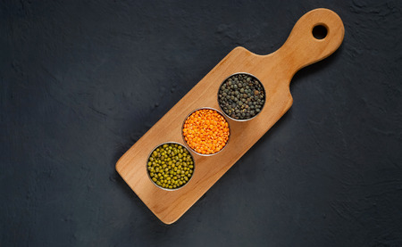 Concept of vegetarian food. Cereals and legumes with the inscription of love on a blue concrete background. Top view, empty space for textの写真素材
