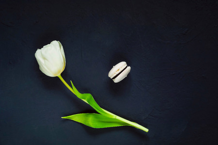 dessert  and a white tulip on a dark background  with hearts, top view, space for text,holiday conceptの写真素材