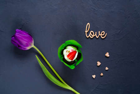 dessert  and a white tulip on a dark background  with hearts, top view, space for text,holiday conceptの写真素材