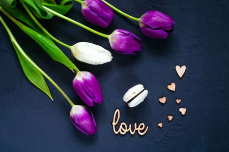 sweet dessert and bouquet of ultraviolet tulips on blue background, top view, space for textの写真素材