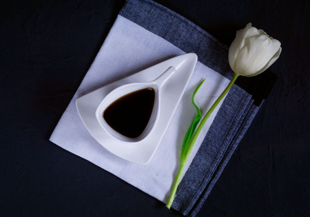 vintage white ceramic cup of coffee on a fabric texture on a blue concrete background, top view, space for textの写真素材