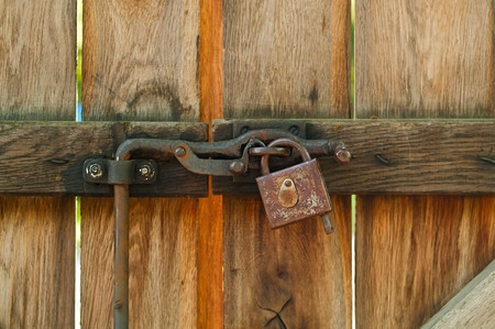 vintage lock on a rusty loop on a wooden background, copy space, concept of authentic objectsの写真素材