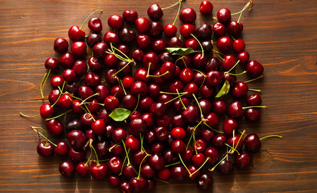 Fresh cherries. Cherry on wooden background,sweet  food in summer. Flat lay, Top view,copy space, closeupの写真素材