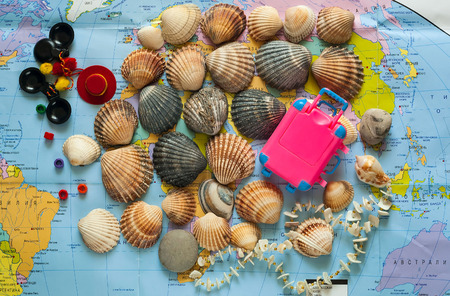 background of stones and seashells on the world map. The concept of travel.Flat lay,closeup,copy spaceの写真素材