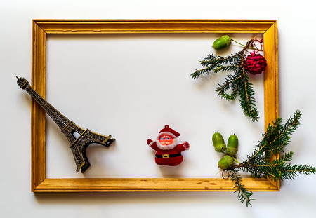 New Year's wooden frame with spruce branches, eiffel tower and Santa Claus on  white background,copy space, closeup, flat lay, isolatedの写真素材