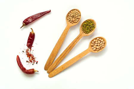 Wooden Spoon  with  Raw cereals isolated on white background. The concept of cereals organic...