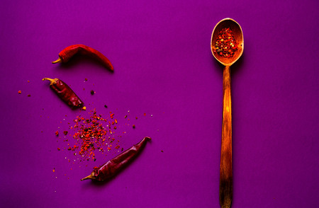 wooden spoon with spices  for cooking on purple background.Healthy food, vegan or diet nutrition...