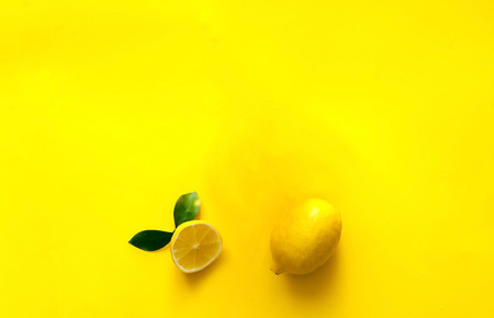 whole and half lemon, Creative yellow background-color of the year 2019,closeup, copy space,isolated