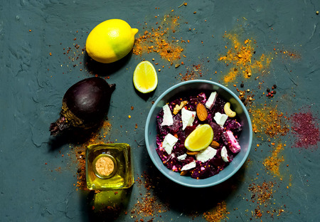 dietary salad of beet, goat cheese and nuts with french mustard in blue bowl on dark blue concrete background,organic food concept.の写真素材
