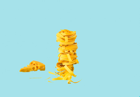 Food Background of Italian Pasta. Pasta fettuccine and tagliatelle on blue background. Close-up, copy space.の写真素材
