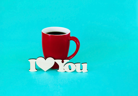 Valentines Day concept. Big red cup of coffee with stamp i love you on turquoise background. Concept...