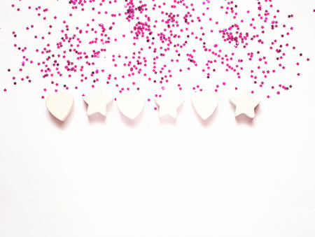 Purple Confetti and stars on white background. Festive backdrop for package and projects. Flat lay,...