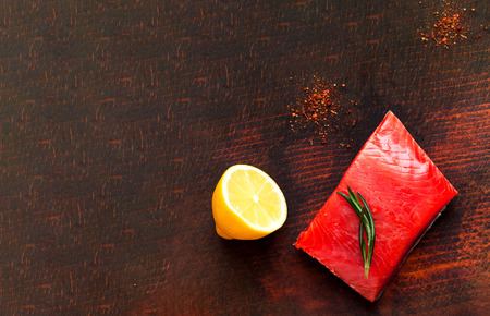 Salmon fillet on wooden background. Healthy eating concept.