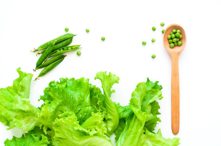 Wooden spoon and vegetables on isolated white background. The concept of organic products for cooking. Close-up, copy spaceの写真素材