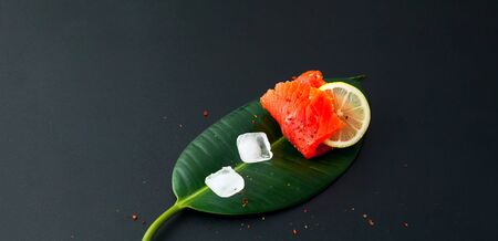 The concept of organic food.Salmon fillet  on dark background. Close-up, copy spaceの写真素材