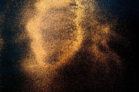Black background with golden sparkles. Blurred  effect. Concept for festive background or for project.Close-up,copy spaceの写真素材