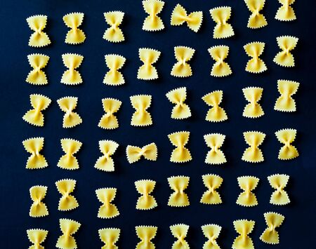 Pattern from Italian pasta farfalle. Food concept. Close-up, copy space