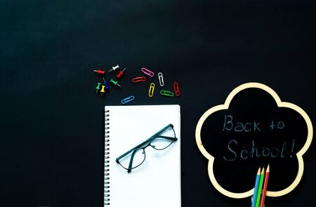 Back to school over chalkboard background. School supplies on black background.Close-up, copy spaceの写真素材