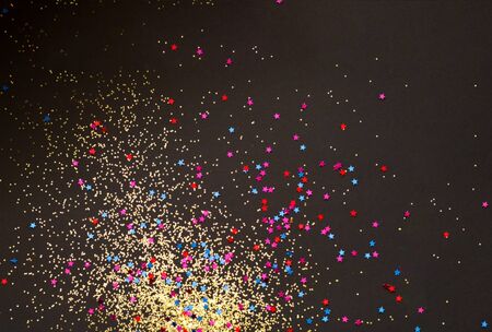 Black background with golden sparkles. Blurred  effect. Concept for festive background or for project.Close-up,copy spaceの写真素材