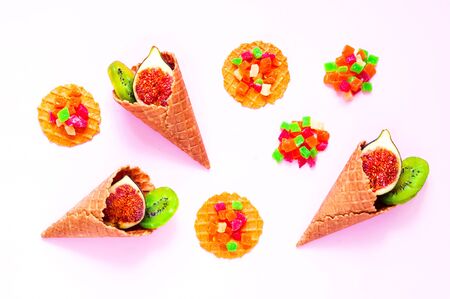 Waffle cones with organic fruits and sweets. Sweetest Day. Close-up, copy spaceの写真素材