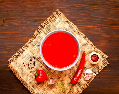 Mexican soup with chili pepper on wooden background. Close-up, copy space