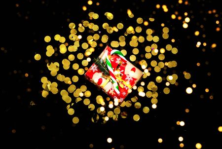 Christmas presents on black background with sparkles. Blurred effect. Close-upの写真素材