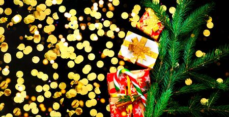 Christmas presents on black background with sparkles. Blurred effect. Close-up, copy spaceの写真素材