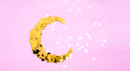 Festive background with golden sparkles Muslim crescent shaped. Blurred effect. Close-up