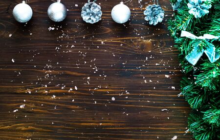 Christmas decor. Decorative fir tree with silver decoration and silver balls on wooden background. Close-up, copy spaceの写真素材