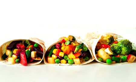 Mexican tortilla with vegetable and mushroom fillings on white background. Healthy eating concept....
