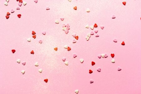 Valentines Day. Heart shape formed of sweet confetti on blue background. Template mock up of greeting card or text design. Copy spaceの写真素材