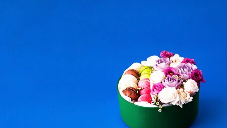 Festive box with rosebuds in full bloom on blue background. Valentines Day. Close-up, copy spaceの写真素材