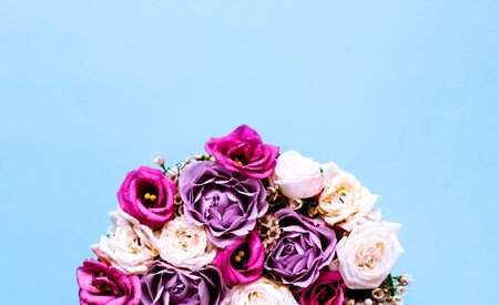 Festive concept from rosebuds in full bloom. Isolated on blue. Valentines Day. Template mock up of greeting card or text design. Close-upの写真素材