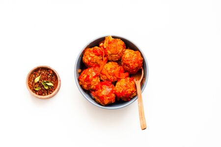 Meatballs in blue bowl on white isolated background. Close-up, copy space