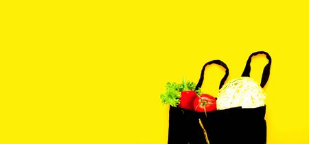 Eco bag with vegetables on yellow background.Concept Zero Waste. Close-up, copy spaceの写真素材