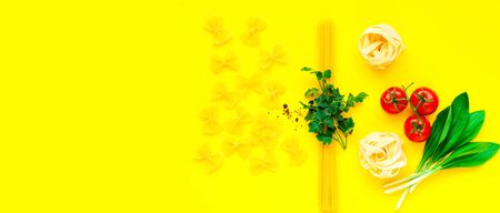 Various uncooked pasta on yellow background. Food concept. Top view, close-up, copy space.の写真素材