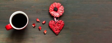 Big red cup of coffee and decorative heart on festive wooden background. Mothers Day concept. Close-upの写真素材