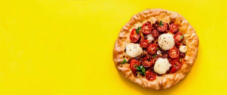 Homemade pizza on yellow background. The concept of traditional Italian food. Stay at homeの写真素材
