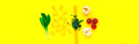 Uncooked homemade fettuccine noodles with ingredients on yellow background. The concept of nutrition and sustainable health. Top view, close-up, copy space.の写真素材