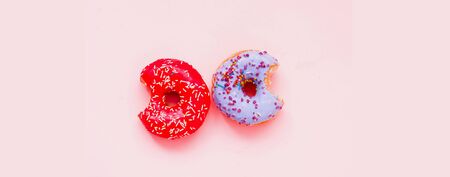 Colored donuts with colorful sprinkles on pink background. National Donut or Doughnut day concept....