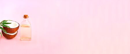 Coconut with coconut oil on pink background. Copy space, close upの写真素材