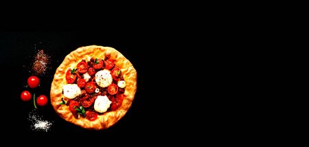 Classic homemade pizza on dark background. Italian food. Happiness is in small thngs. Close-up, copy space.の写真素材