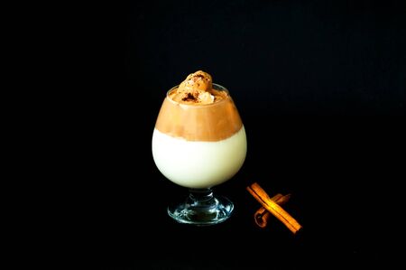 Trendy cold Korean and Indian drink. Dalgona coffee in glass cup on dark background. Hello Summer concept. Close-upの写真素材
