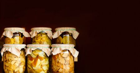Homemade mushrooms in glass jars. Concept of canning organic products. Close-up, copy spaceの写真素材