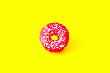 Colored donuts with colorful sprinkles on yellow background. Donut day concept. Close-upの写真素材