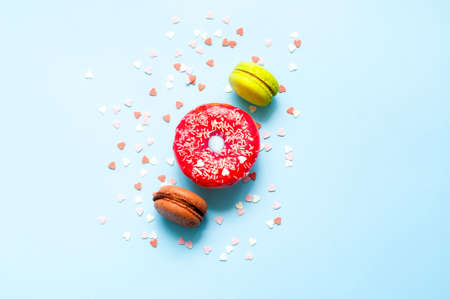Colored donuts with colorful sprinkles on blue background. Donut day concept. Close-upの写真素材